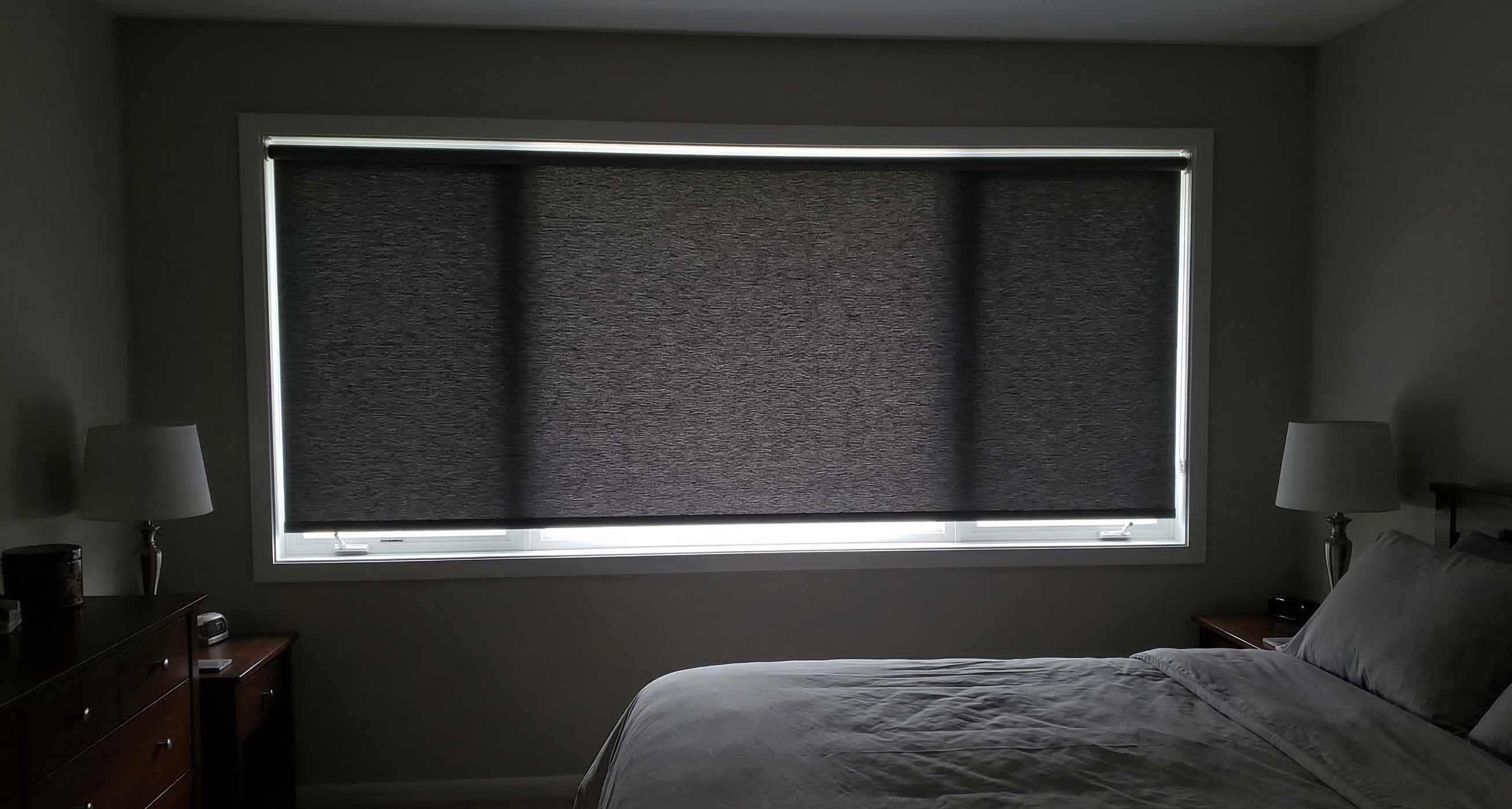 Bedroom after blackout roller shades installed
